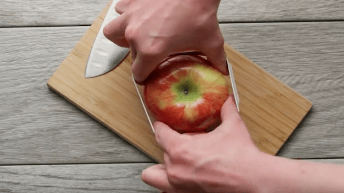 Im nächsten Schritt wickelst du das Gummiband um den Apfel.